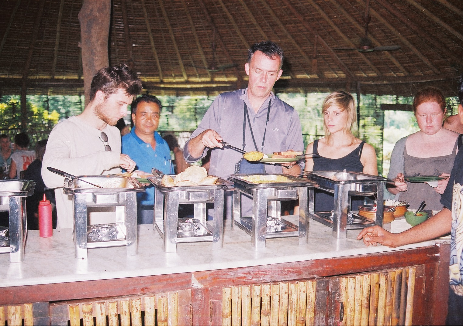 Guests at the breakfast buffet under the thatched roof at Corbett Wild Restaurant